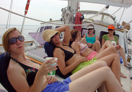 5 women hanging amidships